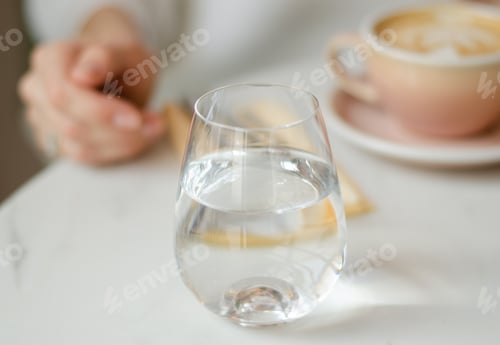 Preview: Refreshing Water and Coffee Drink on White Table