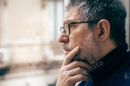 Preview: Senior man mental health reflection at home window in calm lifestyle