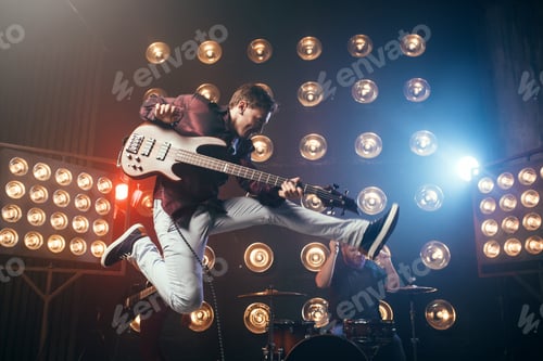 Preview: Guitarist plays on bas-guitar, snapshot in a jump
