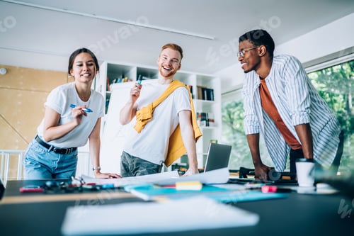 Preview: Happy worker drawing layout of project with colleagues