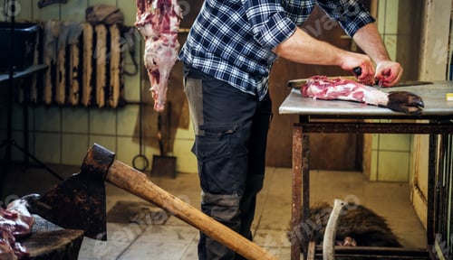 Preview: Close up image of axe over bearded butcher on background.