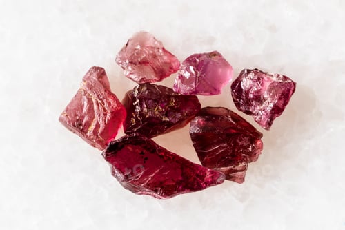Preview: sample of several raw pyrope crystals on white