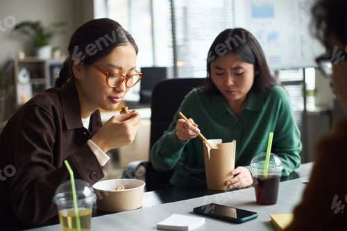 Preview: Young Asian Businesswomen Eating Lunch Together during Office Work Break