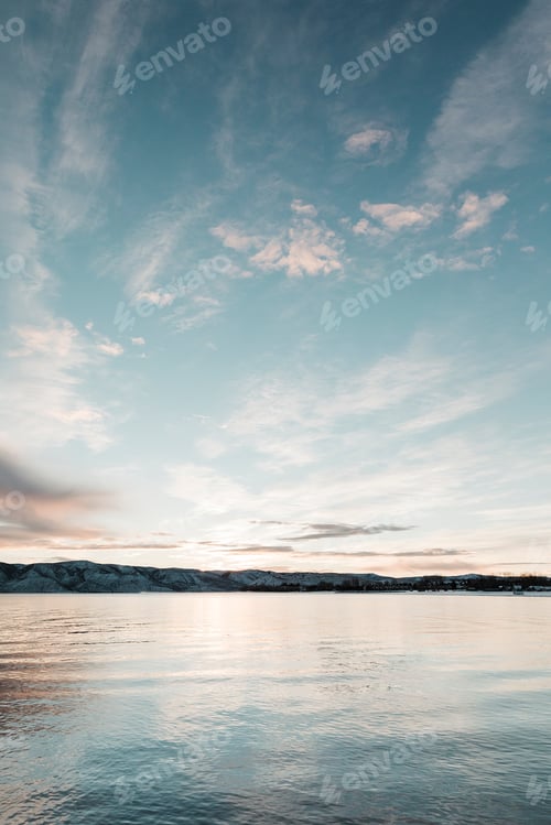 Preview: sunrise reflecting over a blue lake