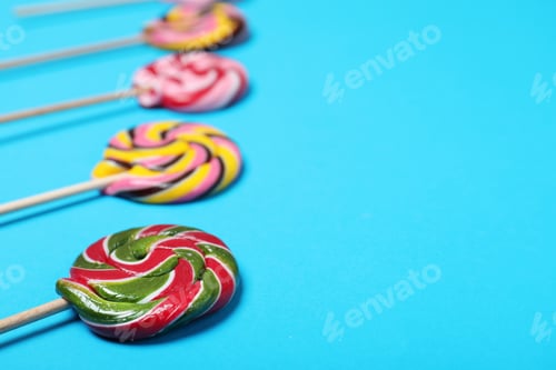Preview: Bright yummy candies on color background. Space for text