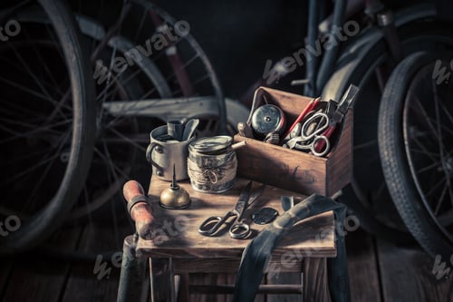 Preview: Old bicycle repair workshop with tools, wheels and tube