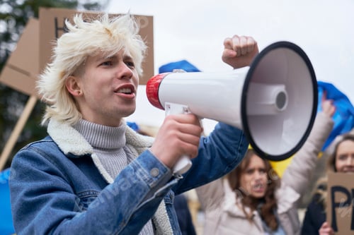 Preview: Close up of caucasian man screaming through megaphone