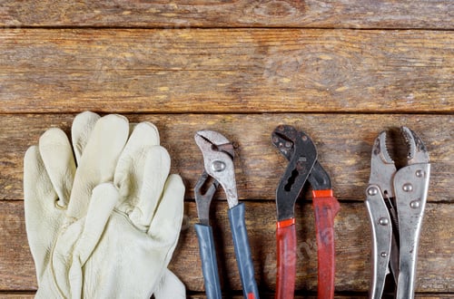 Preview: Work Gloves and Pliers on Weathered Wood Surface