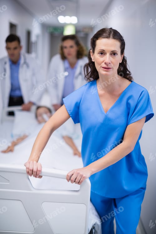 Preview: Doctors pushing emergency stretcher bed in corridor