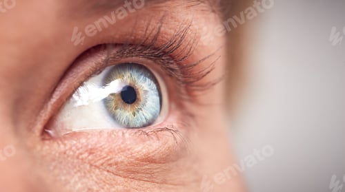 Preview: Extreme Close Up Of Eye Of Woman Against White Studio Background