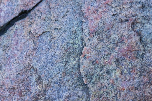 Preview: Texture Of Granite Close Up. Granite Rock With Reddish Color. Background From Solid Stone. Pattern