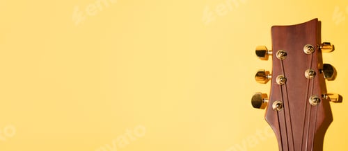 Preview: Acoustic guitar neck on a yellow background. Banner, copy space