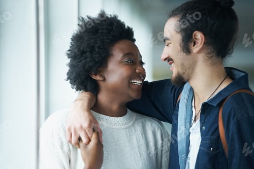 Preview: Hes so cute. A young couple standing together and sharing a smile.
