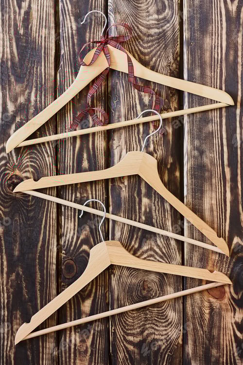 Preview: Wooden Hangers with Red Ribbon on Wood Background