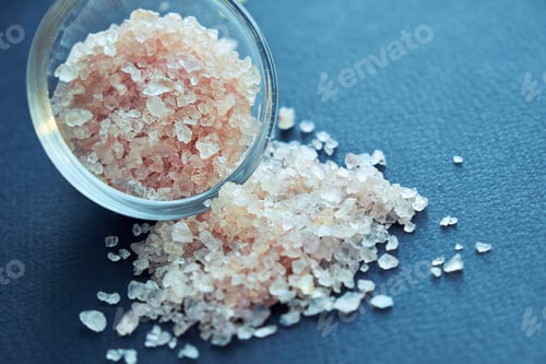 Preview: bowl of pink himalayan salt on dark table, top view, copy space