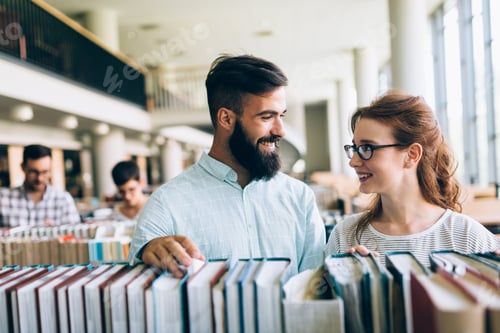 Preview: Young attractive students spending time in library