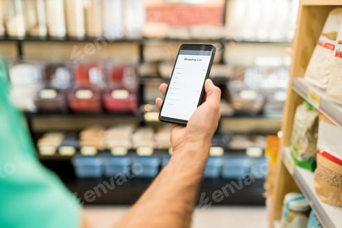 Preview: Male Customer Using Mobile Phone In Supermarket