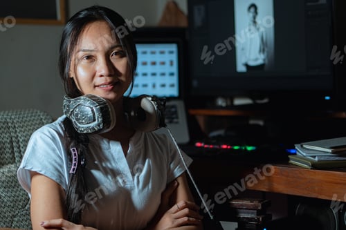 Preview: Woman with headphones working on photo editing