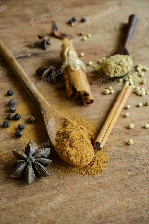 Preview: Cinnamon sticks, star anise and coriander powder on wooden table