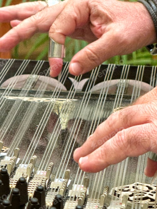 Preview: A Middle East male unrecognizable musician plays a traditional string instrument called a quanun