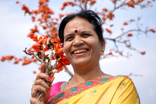 Preview: Portrait of Indian woman with flower in outdoor.