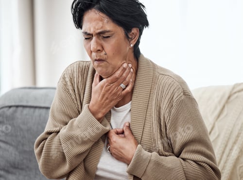 Preview: Senior woman, cough and sick on sofa in home, chest pain and pneumonia with tuberculosis. Pensioner