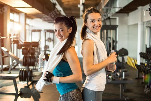 Preview: Two young sporty women in the gym.