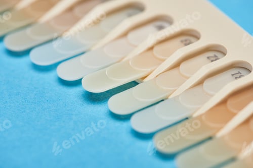 Preview: selective focus of teeth palette with different shades on blue
