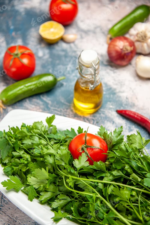 Preview: front view fresh greens with tomatoes on the light-blue background ripe salad photo color