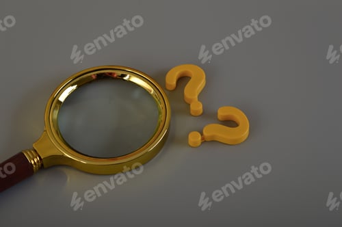 Preview: Magnifying glass and question mark symbols isolated on a grey background