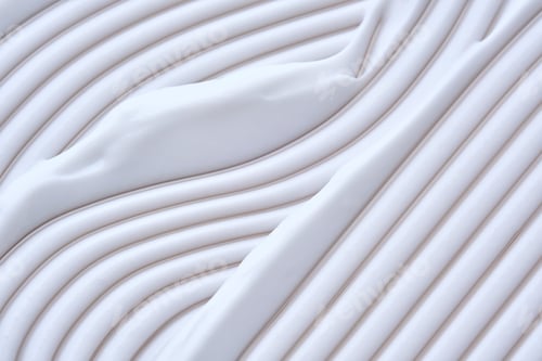 Preview: Beautiful waves of cream close-up. Beauty background.