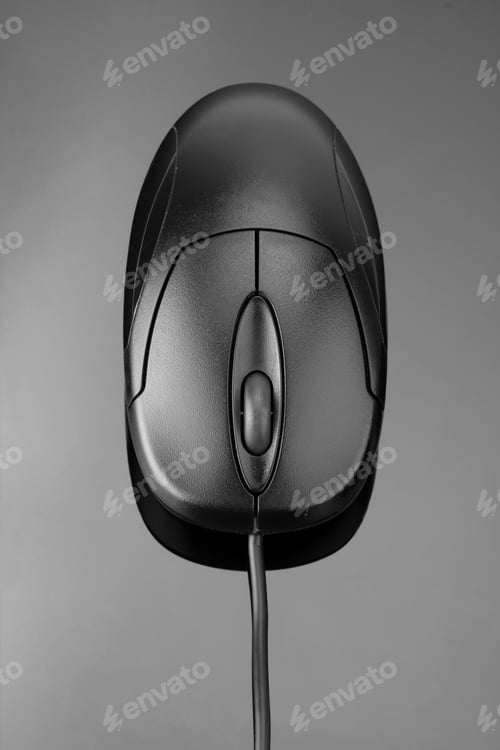 Preview: Computer Mouse On Reflective Grey Surface. In B/W