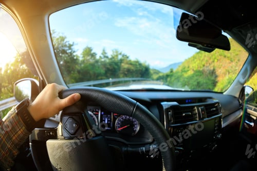 Preview: People driving car on sunrise mountain road