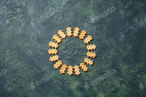 Preview: top view little salted crackers in circle shape on a dark background crisp color snack cips salt