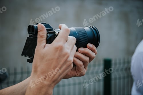 Preview: Closeup of a camera and a male hands taking shots