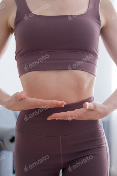 Preview: Close up shot of a young woman doing yoga exercises in the living room at home