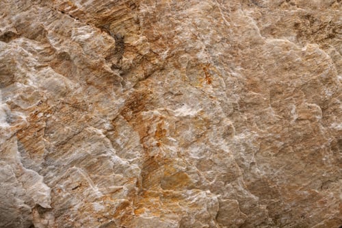 Preview: Background from a photo of a chipped natural stone of gradient brown color with cracks