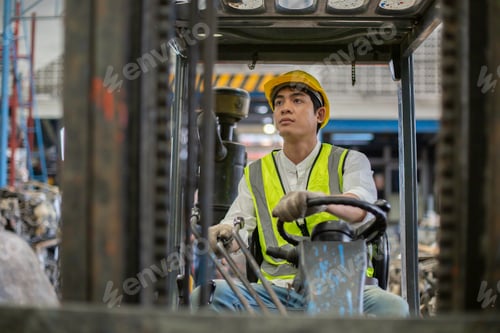 Preview: Man wear safety helmet driver forklift warehouse in factory. Male worker industrial operate.