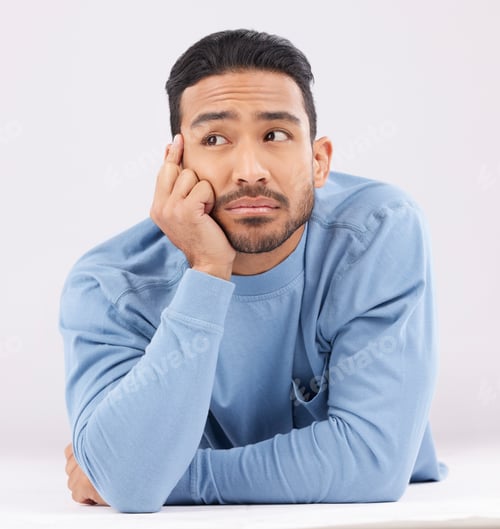 Preview: Thinking, remember and young man in a studio resting on his arms with a contemplating facial expres