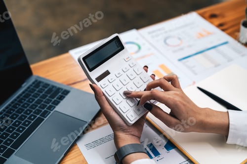 Preview: business woman or accountant working on calculator to calculate business data, accountancy document