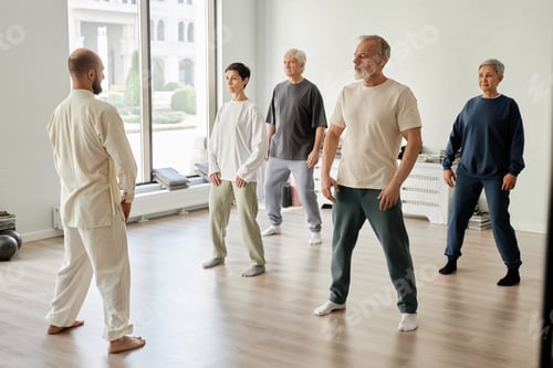 Preview: Group of People Starting Qigong Exercise in Fitness Studio