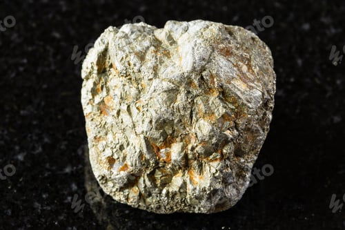 Preview: sample of unworked pyrite mineral on black granite