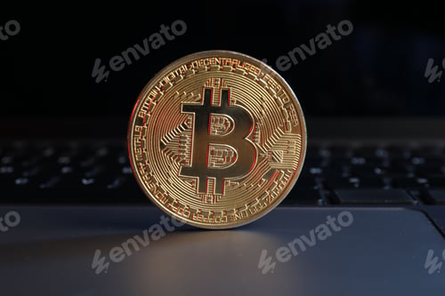 Preview: Cryptocurrency. Golden bitcoin on laptop, closeup view