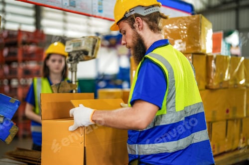 Preview: Warehouse worker folding paper box for packing the items in a large warehouse