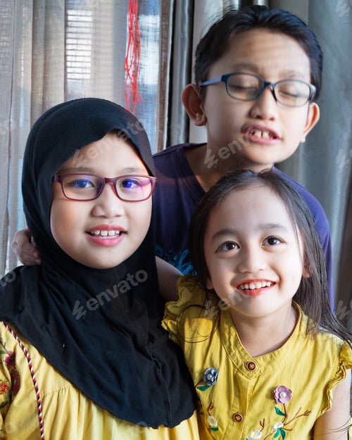 Preview: Older sister with siblings. Asian Muslim kids. Happy children during Ramadan and Eid Mubarak or Hari
