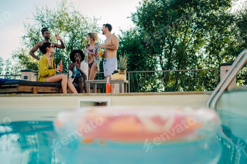 Preview: Friends enjoying drinks by the poolside during summer vacation