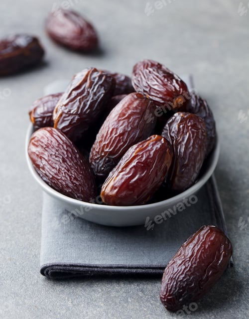 Preview: Fresh Medjool Dates in Bowl. Grey Background. Close up.