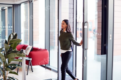 Preview: Businesswoman Arriving For Work At Office Walking Through Door
