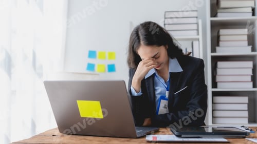 Preview: oung Asian businesswoman stressed by overwork at office