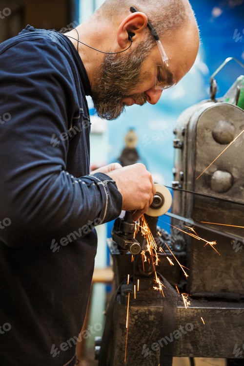 Preview: Man standing in a shoemaker's workshop wearing safety glasses, using a machine.